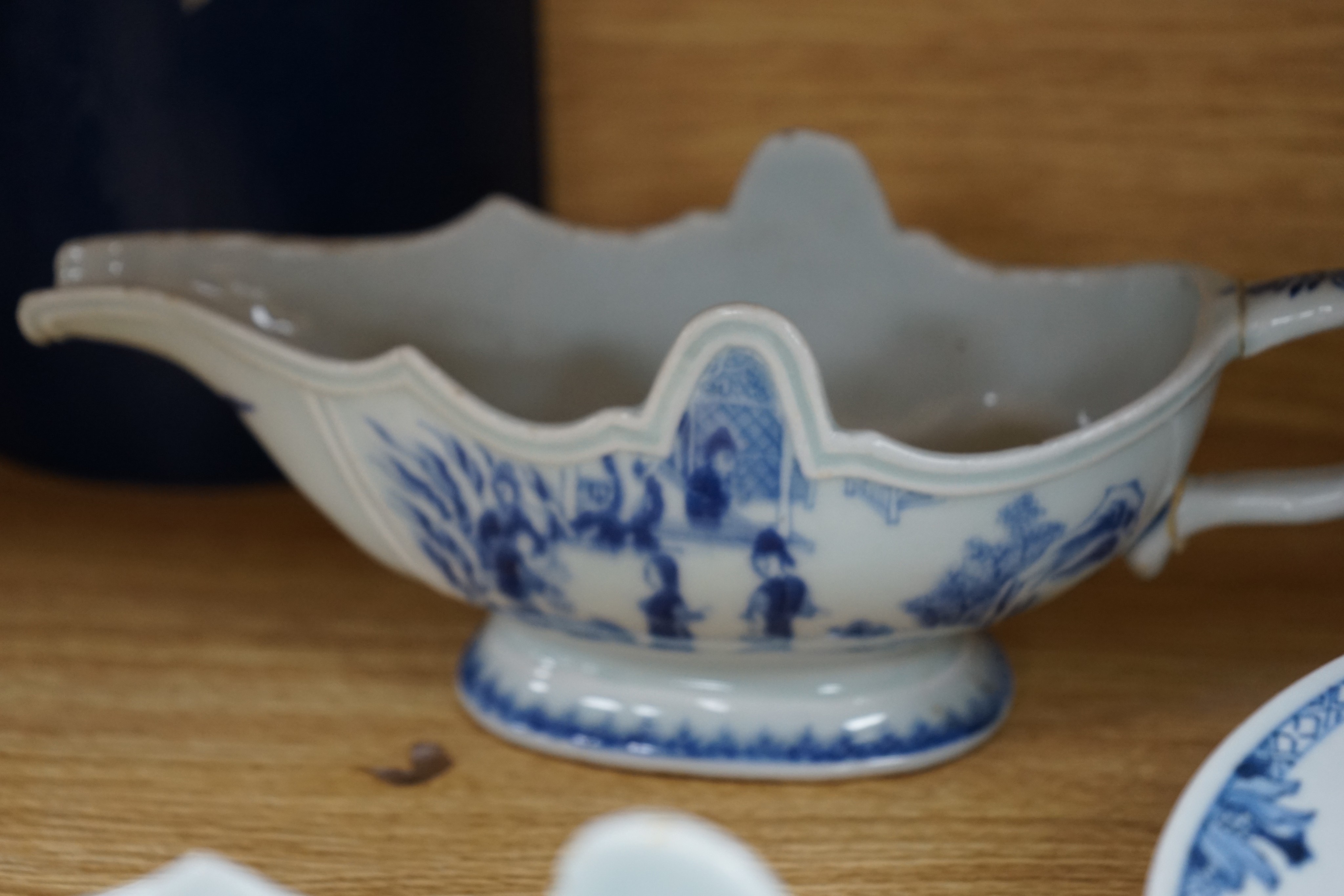 An 18th century Chinese Export blue and white octagonal tureen and cover, decorated with birds and flowers, a pair of similar sauceboats and five plates decorated with urns of flowers